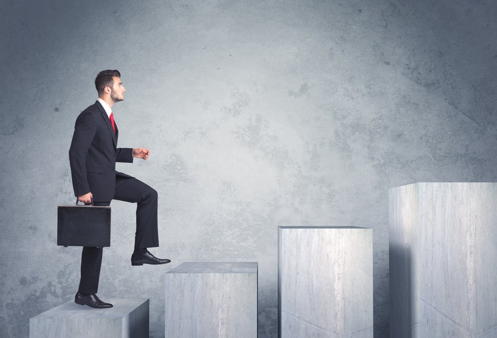 Business person stepping up a staircase