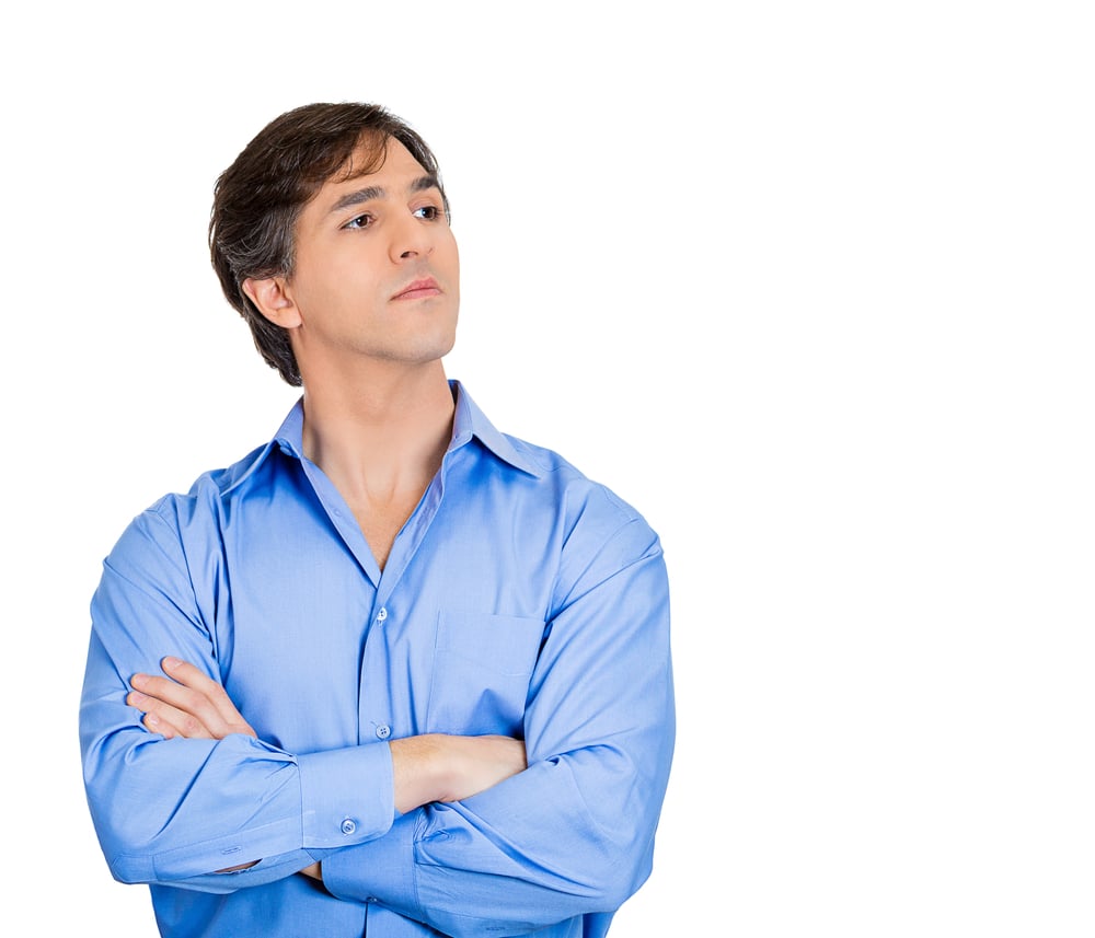 Closeup portrait of young grumpy man arms crossed, bad attitude, does not want to listen to your explanation, isolated white background. Negative emotions, facial expression feelings, body language