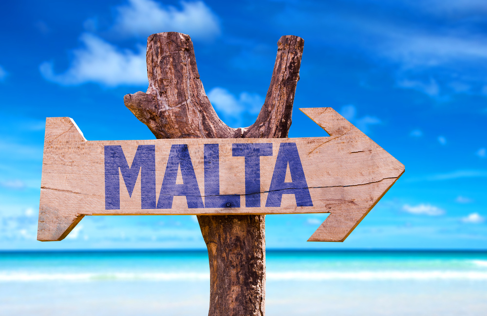 Malta wooden sign with beach background