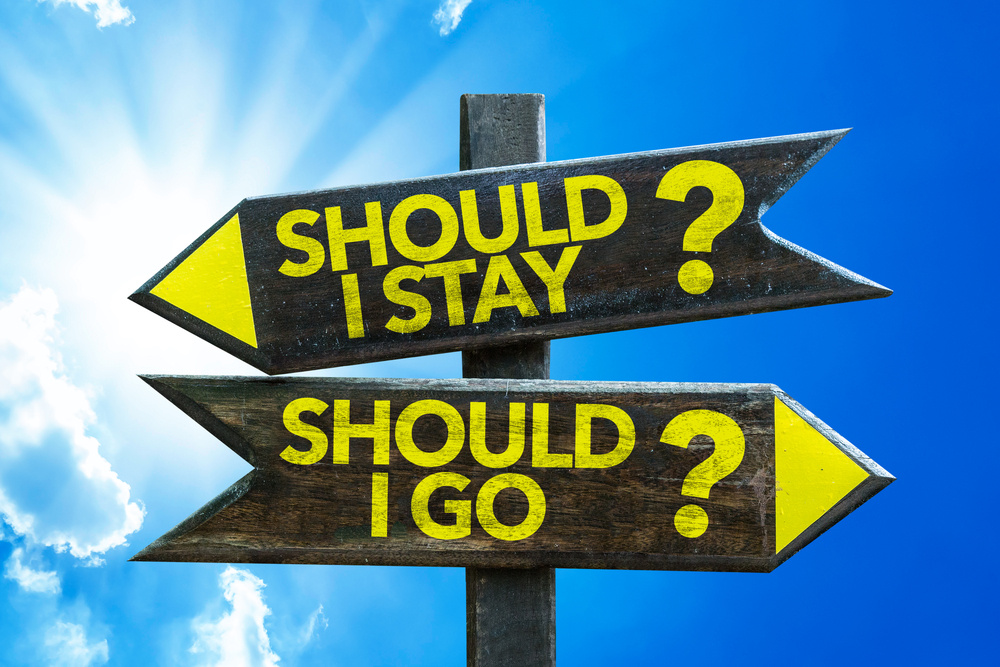 Should I Stay? Should I Go? signpost with sky background-1