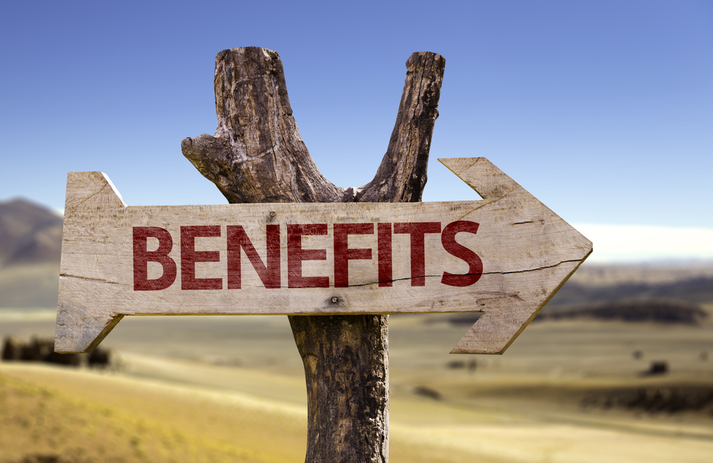 Benefits wooden sign on desert background