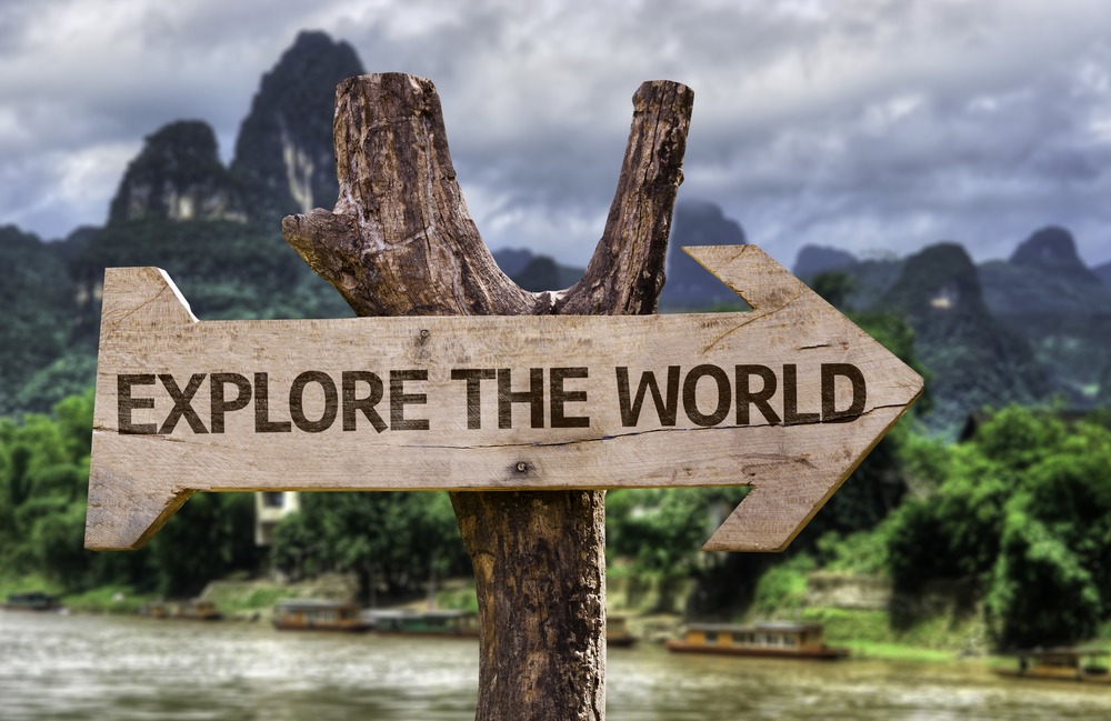 Explore the World wooden sign with a forest background